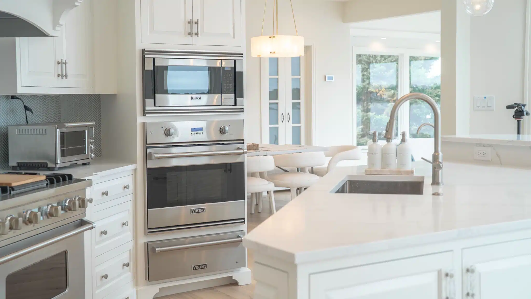 Designer kitchen with quartz counters, custom cabinetry, large island, and high-end appliances