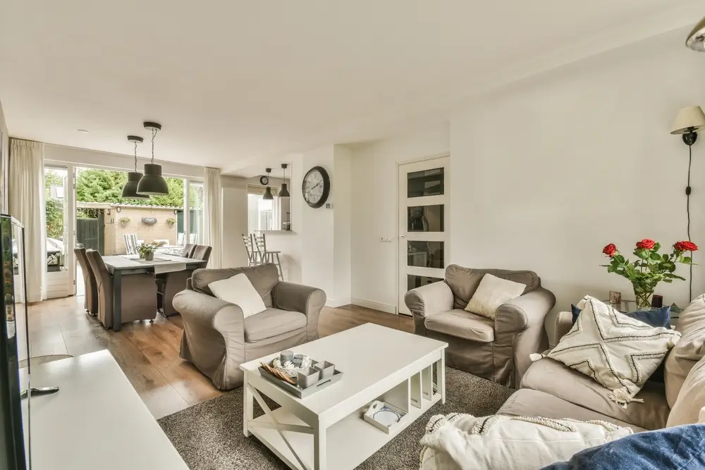 Open-concept interior living and dining area in an in-law suite with wide walkways and patio door access.
